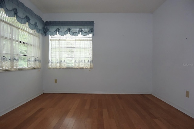 11364 Orangewood Ct, Spring Hill, FL 34609 - empty room with wood finished floors and baseboards