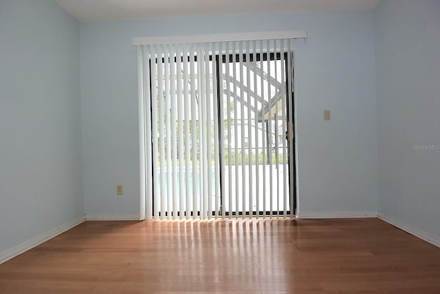 11364 Orangewood Ct, Spring Hill, FL 34609 - spare room featuring wood finished floors and baseboards