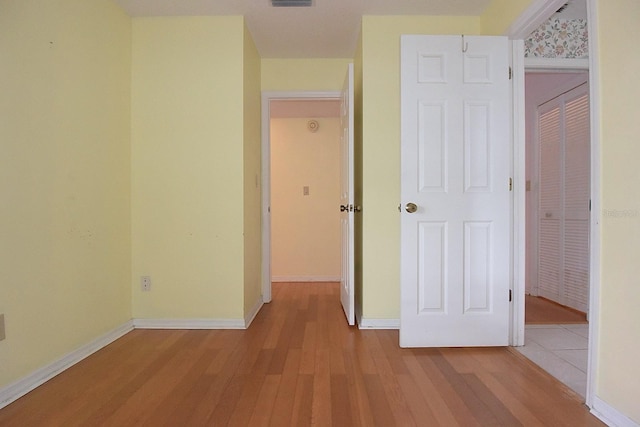 11364 Orangewood Ct, Spring Hill, FL 34609 - unfurnished bedroom with wood finished floors, a closet, and baseboards