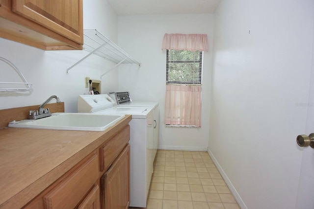 11364 Orangewood Ct, Spring Hill, FL 34609 - washroom featuring washing machine and clothes dryer, cabinet space, baseboards, and light tile patterned floors
