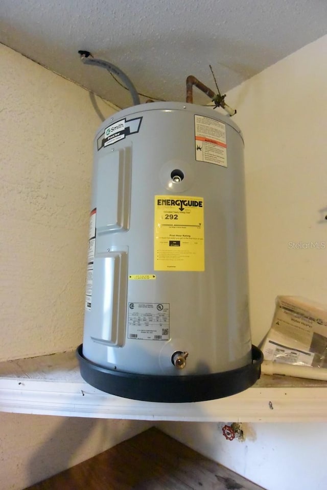 11364 Orangewood Ct, Spring Hill, FL 34609 - utility room featuring electric water heater