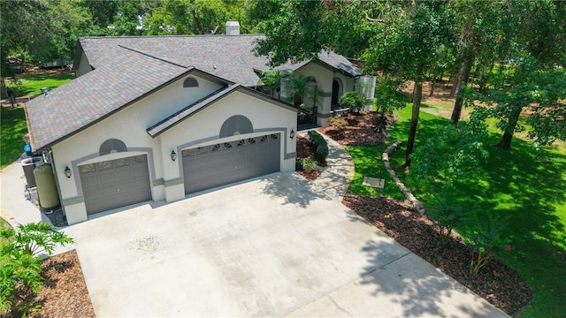 8518 Quail Hollow Blvd, Wesley Chapel, FL 33544 - view of front of property featuring driveway, a garage, stucco siding, a front yard, and a chimney