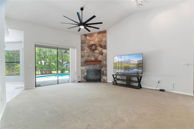 8518 Quail Hollow Blvd, Wesley Chapel, FL 33544 - unfurnished living room featuring lofted ceiling, ceiling fan, carpet flooring, a stone fireplace, and baseboards
