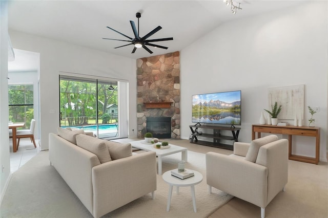 8518 Quail Hollow Blvd, Wesley Chapel, FL 33544 - living area featuring vaulted ceiling, ceiling fan, a fireplace, light carpet, and baseboards