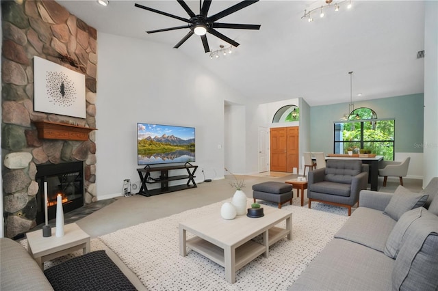 8518 Quail Hollow Blvd, Wesley Chapel, FL 33544 - carpeted living area featuring ceiling fan, a fireplace, and high vaulted ceiling