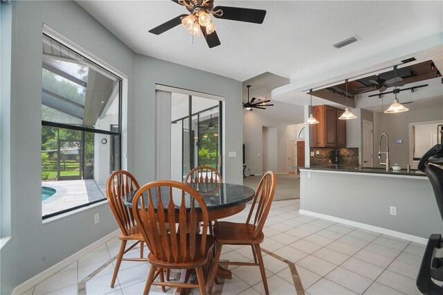 8518 Quail Hollow Blvd, Wesley Chapel, FL 33544 - dining area featuring a ceiling fan, light tile patterned floors, healthy amount of natural light, and baseboards