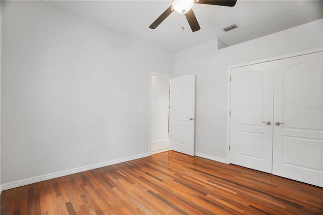 8518 Quail Hollow Blvd, Wesley Chapel, FL 33544 - unfurnished bedroom with wood finished floors, baseboards, a closet, and ceiling fan