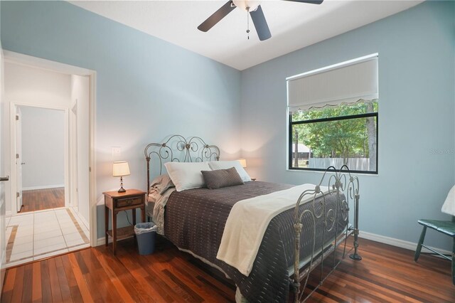 8518 Quail Hollow Blvd, Wesley Chapel, FL 33544 - bedroom with wood finished floors, baseboards, and ceiling fan