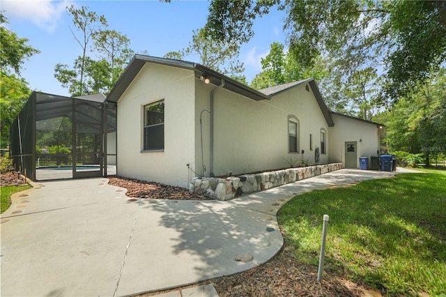 8518 Quail Hollow Blvd, Wesley Chapel, FL 33544 - view of home's exterior with stucco siding, a patio area, a pool, and glass enclosure