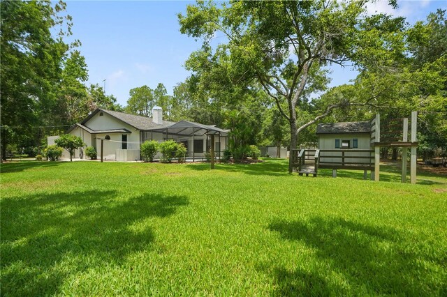 8518 Quail Hollow Blvd, Wesley Chapel, FL 33544 - view of green lawn with glass enclosure and view of scattered trees