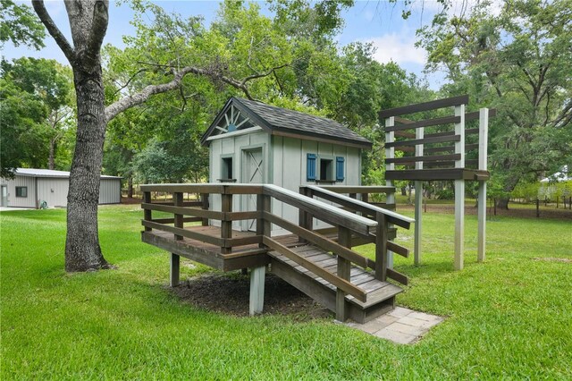8518 Quail Hollow Blvd, Wesley Chapel, FL 33544 - view of property's community with an outdoor structure, a yard, a deck, and view of wooded area