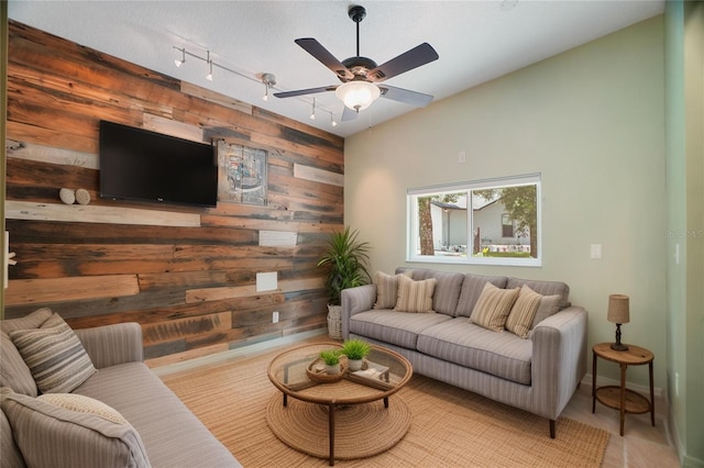 8518 Quail Hollow Blvd, Wesley Chapel, FL 33544 - living room featuring wood walls, track lighting, ceiling fan, and baseboards