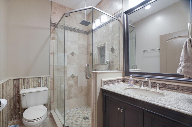 8518 Quail Hollow Blvd, Wesley Chapel, FL 33544 - full bath featuring toilet, vanity, a shower stall, and a wainscoted wall