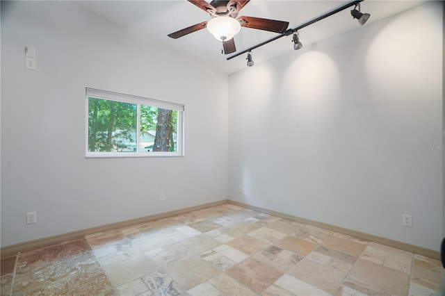 8518 Quail Hollow Blvd, Wesley Chapel, FL 33544 - empty room with track lighting, stone tile floors, ceiling fan, and baseboards
