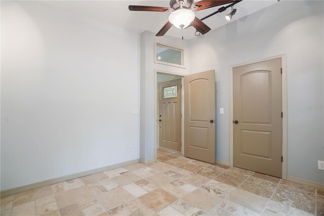 8518 Quail Hollow Blvd, Wesley Chapel, FL 33544 - unfurnished room with stone tile floors, ceiling fan, and baseboards