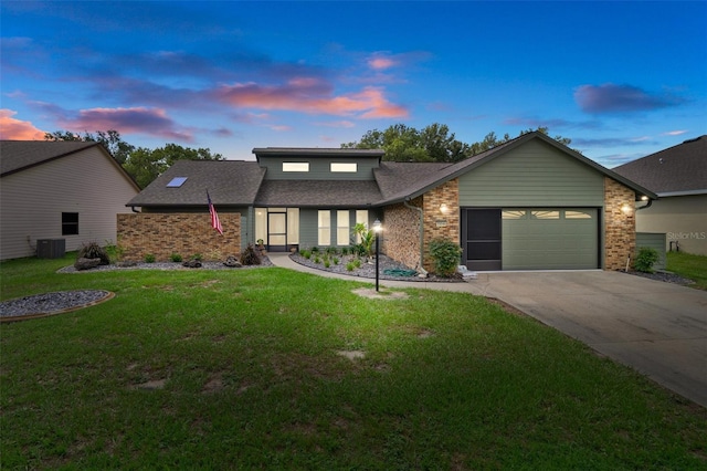 35046 Smoketree Ln, Dade City, FL 33523 - mid-century home with brick siding, concrete driveway, an attached garage, and a lawn
