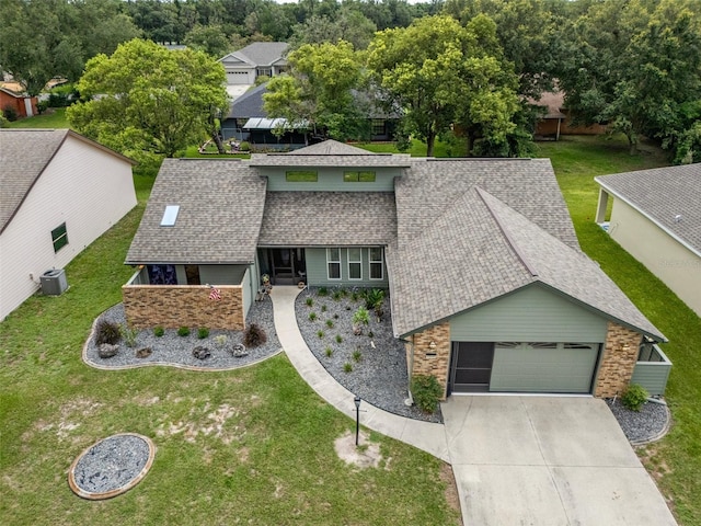 35046 Smoketree Ln, Dade City, FL 33523 - view of front of property featuring a shingled roof, a garage, a front lawn, and concrete driveway