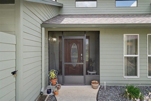 35046 Smoketree Ln, Dade City, FL 33523 - view of exterior entry featuring a shingled roof