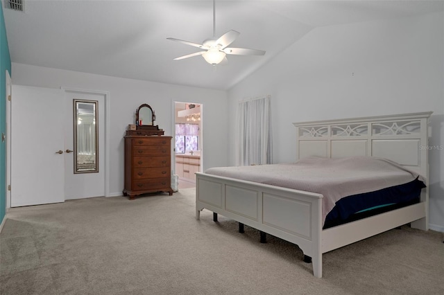 35046 Smoketree Ln, Dade City, FL 33523 - bedroom with vaulted ceiling, light carpet, ceiling fan, and connected bathroom