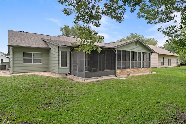 35046 Smoketree Ln, Dade City, FL 33523 - back of property with a sunroom, a yard, and roof with shingles