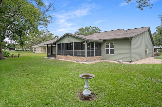 35046 Smoketree Ln, Dade City, FL 33523 - rear view of house featuring a sunroom, a lawn, and roof with shingles