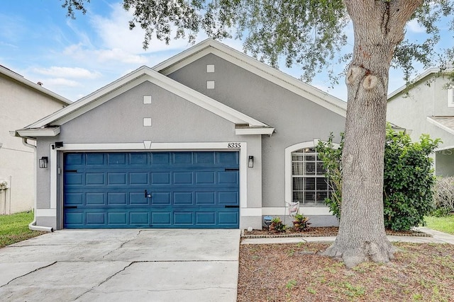 8335 Crescent Moon Dr, New Port Richey, FL 34655 - ranch-style home featuring stucco siding, a garage, and concrete driveway