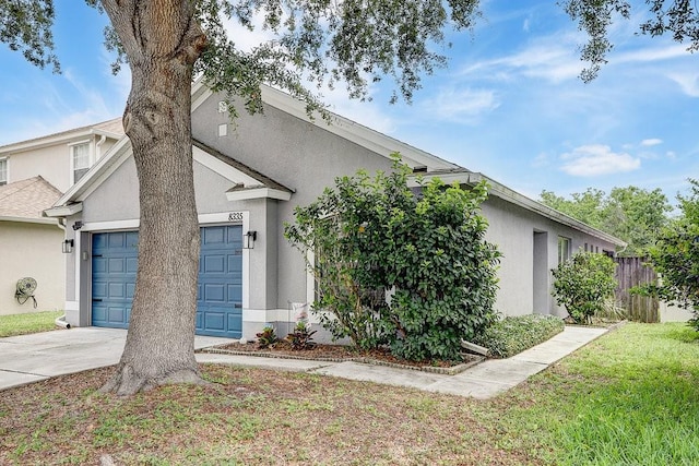 8335 Crescent Moon Dr, New Port Richey, FL 34655 - view of front of house with stucco siding, concrete driveway, and an attached garage