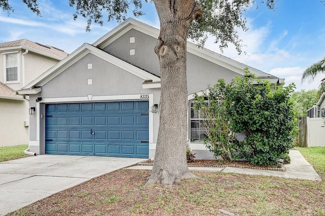 8335 Crescent Moon Dr, New Port Richey, FL 34655 - view of front of property with stucco siding, an attached garage, and concrete driveway