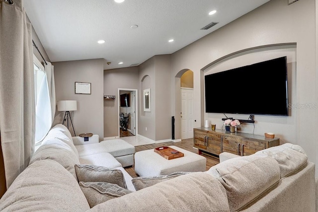 8335 Crescent Moon Dr, New Port Richey, FL 34655 - living area with arched walkways, baseboards, wood finished floors, and recessed lighting