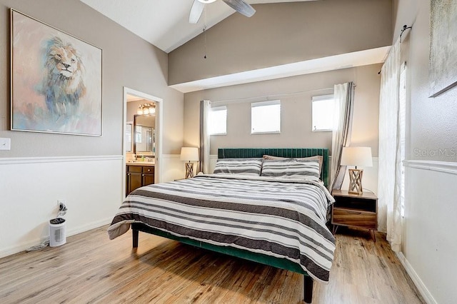 8335 Crescent Moon Dr, New Port Richey, FL 34655 - bedroom with lofted ceiling, light wood-style floors, ensuite bathroom, a ceiling fan, and baseboards