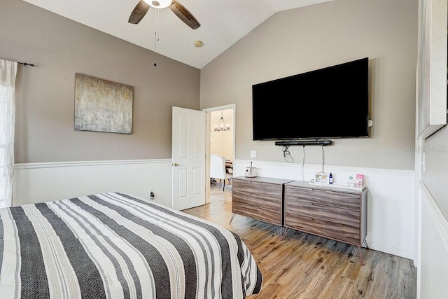 8335 Crescent Moon Dr, New Port Richey, FL 34655 - bedroom featuring light wood finished floors, lofted ceiling, and a ceiling fan