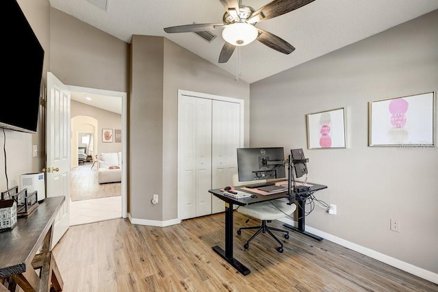 8335 Crescent Moon Dr, New Port Richey, FL 34655 - office featuring arched walkways, a ceiling fan, light wood-style flooring, baseboards, and high vaulted ceiling