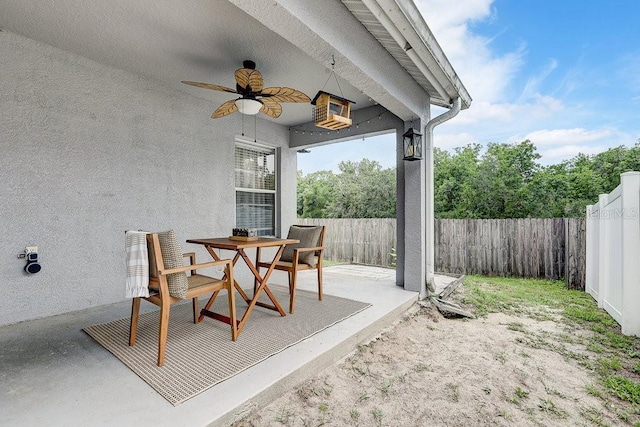 8335 Crescent Moon Dr, New Port Richey, FL 34655 - fenced backyard with ceiling fan and a patio