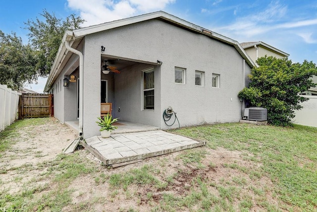 8335 Crescent Moon Dr, New Port Richey, FL 34655 - back of property with ceiling fan, central AC, stucco siding, and a patio