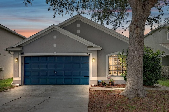 8335 Crescent Moon Dr, New Port Richey, FL 34655 - view of front of property featuring stucco siding, driveway, and an attached garage
