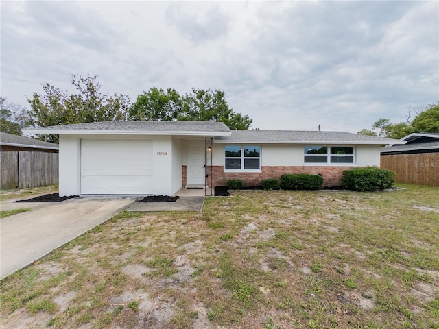 7608 Bougenville Dr, Port Richey, FL 34668 - ranch-style home with driveway, a garage, brick siding, and stucco siding
