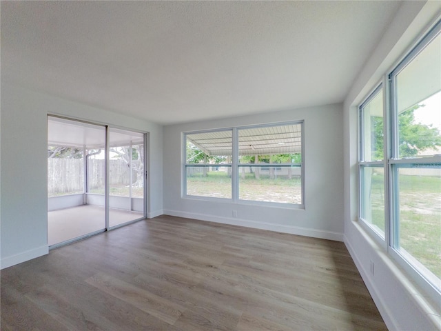 7608 Bougenville Dr, Port Richey, FL 34668 - empty room with wood finished floors and baseboards