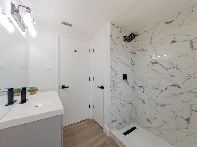 7608 Bougenville Dr, Port Richey, FL 34668 - bathroom featuring vanity, a marble finish shower, and wood finished floors