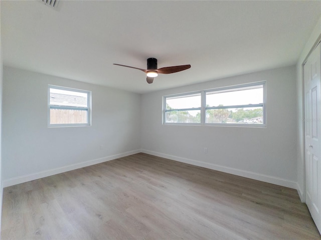 7608 Bougenville Dr, Port Richey, FL 34668 - unfurnished bedroom with light wood-type flooring, baseboards, a ceiling fan, and a closet