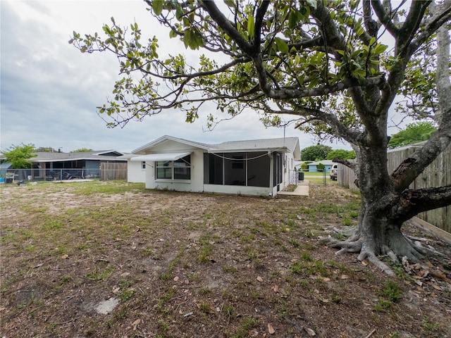 7608 Bougenville Dr, Port Richey, FL 34668 - back of property featuring a sunroom and a fenced backyard