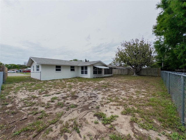 7608 Bougenville Dr, Port Richey, FL 34668 - rear view of house featuring a fenced backyard and stucco siding