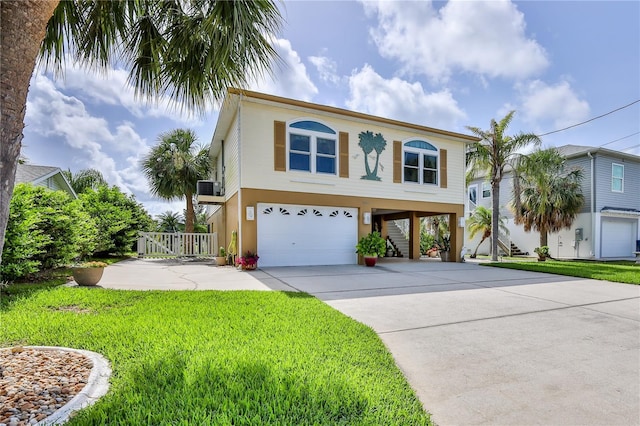 4460 Flounder Dr, Hernando Beach, FL 34607 - beach home featuring a carport, stucco siding, a garage, concrete driveway, and a front yard