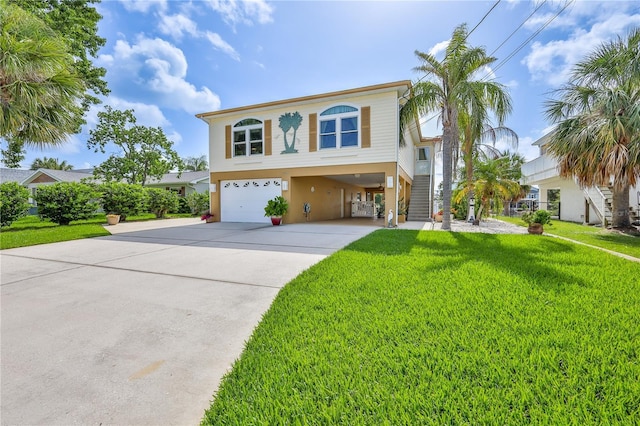 4460 Flounder Dr, Hernando Beach, FL 34607 - view of front of home featuring a garage, driveway, a front yard, a carport, and stucco siding