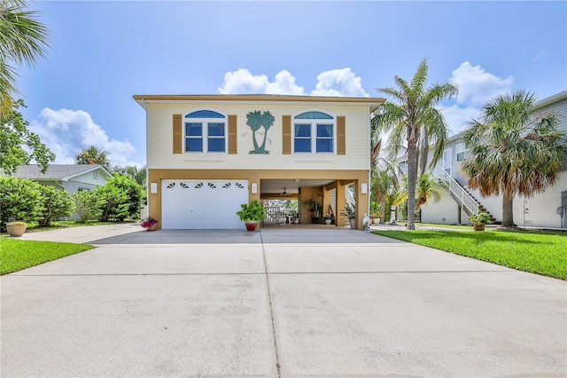4460 Flounder Dr, Hernando Beach, FL 34607 - beach home featuring a carport, driveway, a garage, and stucco siding