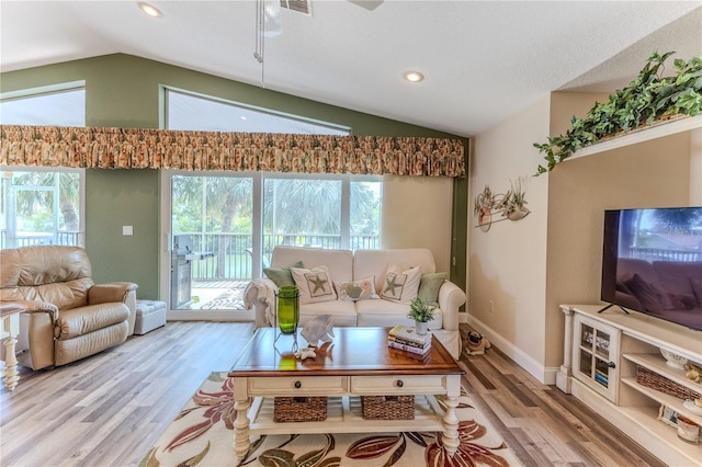 4460 Flounder Dr, Hernando Beach, FL 34607 - living area featuring vaulted ceiling, wood finished floors, and recessed lighting