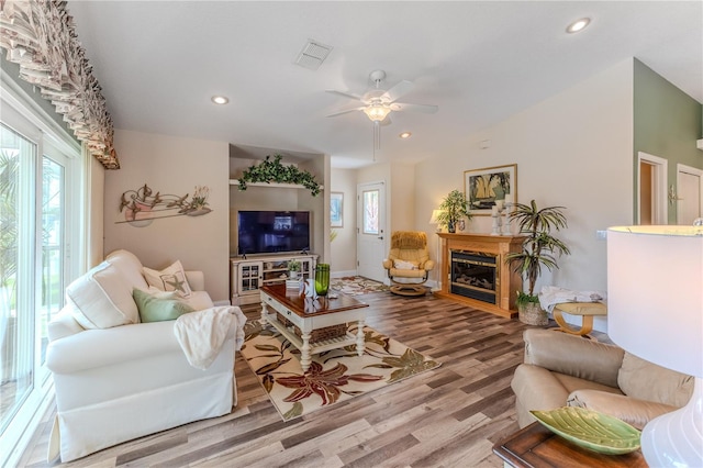 4460 Flounder Dr, Hernando Beach, FL 34607 - living area with wood finished floors, ceiling fan, recessed lighting, and a glass covered fireplace