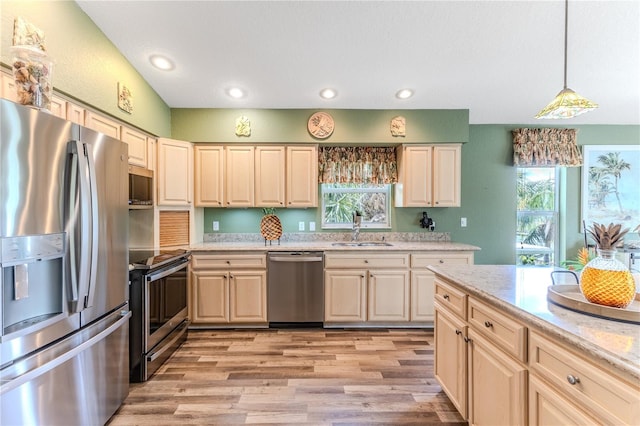 4460 Flounder Dr, Hernando Beach, FL 34607 - kitchen with appliances with stainless steel finishes, light wood-style flooring, pendant lighting, recessed lighting, and light stone countertops