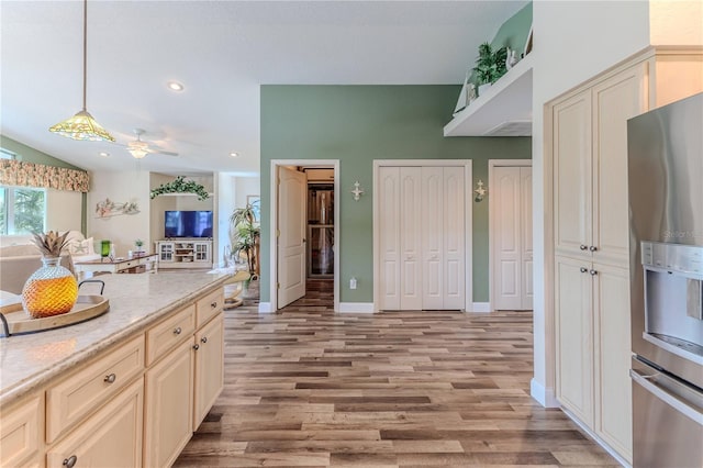 4460 Flounder Dr, Hernando Beach, FL 34607 - kitchen featuring stainless steel fridge, light wood-style floors, ceiling fan, hanging light fixtures, and cream cabinetry