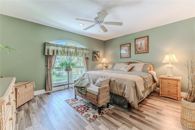4460 Flounder Dr, Hernando Beach, FL 34607 - bedroom featuring light wood-style floors, a textured wall, a ceiling fan, and access to exterior