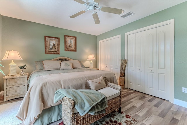 4460 Flounder Dr, Hernando Beach, FL 34607 - bedroom featuring light wood finished floors, two closets, and a ceiling fan